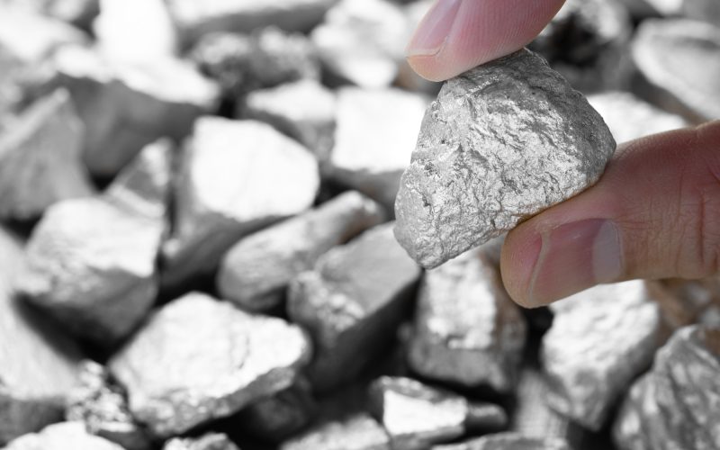 Miners hold in their hands platinum or silver or rare earth minerals